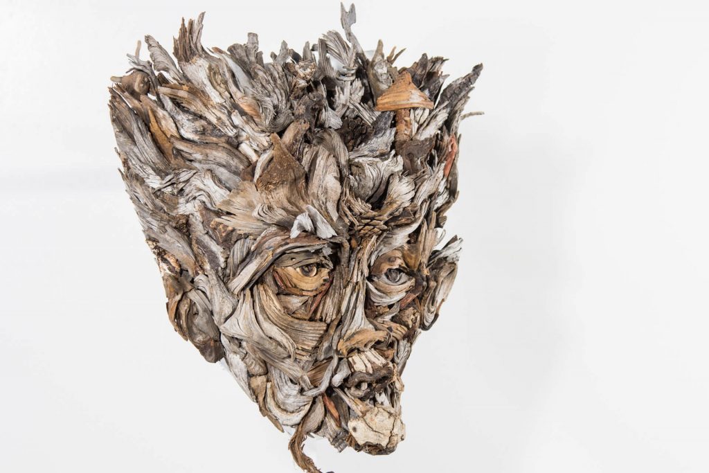 the wall hanging relief faces